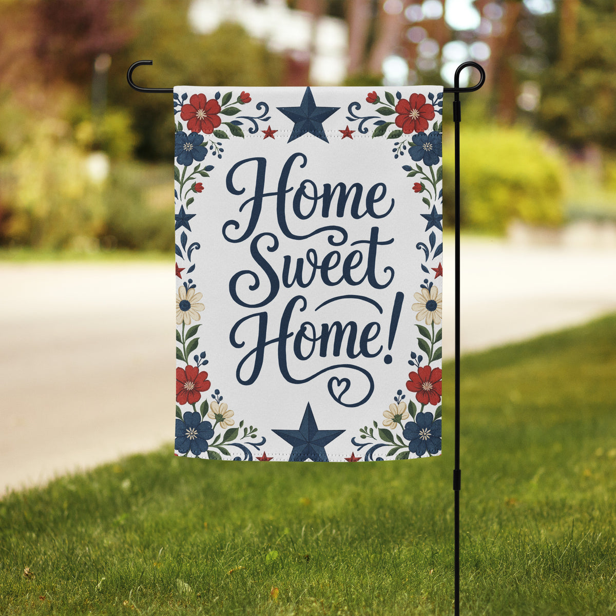 Red, white, and blue floral garden flag with folk-inspired stars and the phrase Home Sweet Home in navy script.